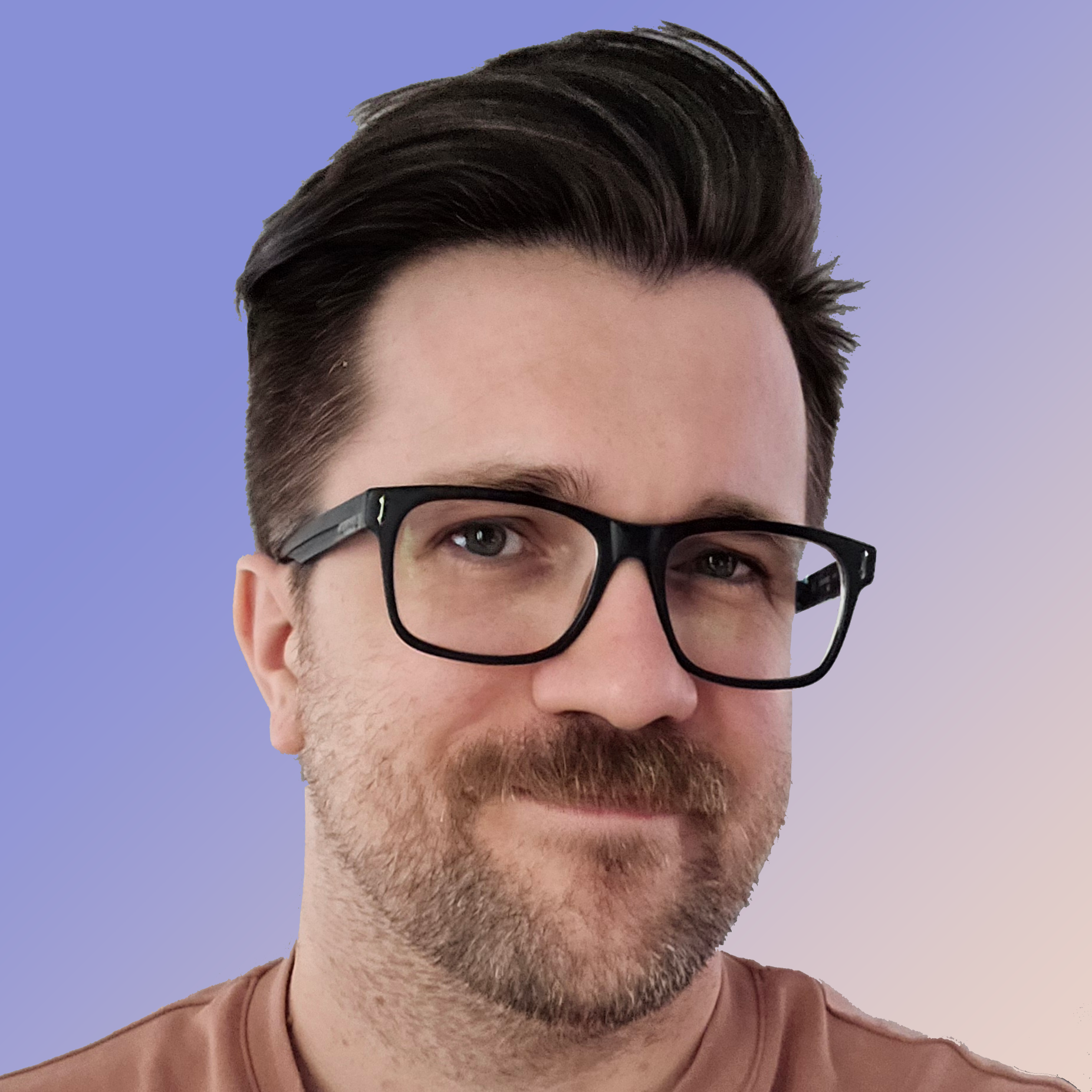 It's me! A white man smiling with medium-short brown hair, glasses, and a grey t-shirt.