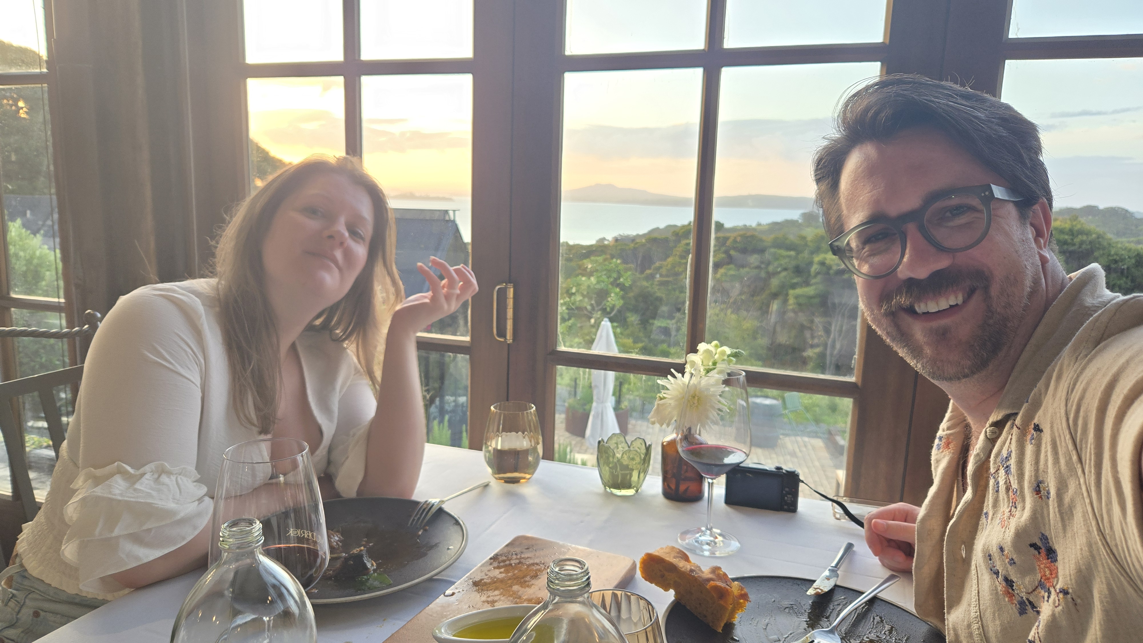 Shelby and I taking a selfie in front of an open view of the water as the sun is setting.